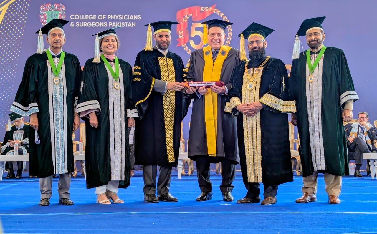 president on stage receiving honorary fellowship in Karachi